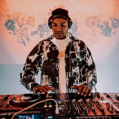 At the controls, mixing live on my Pioneer setup. This shot captures my focus during a high-energy set, ensuring every transition is seamless.