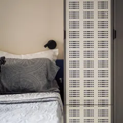 A detail of the custom Murphy bed and wardrobe unit. The perforated panel adds a graphic element and provides ventilation.