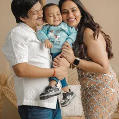 The perfect family hug, full of laughter and warmth. This is a classic family portrait from a studio session, showing the beautiful bond between parents and their child. It’s a timeless, frame-worthy memory of pure happiness.