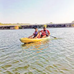 Two friends enjoy a peaceful afternoon of kayaking. This is a perfect activity for exploring calm lakes and rivers at your own pace, offering a mix of gentle exercise and beautiful scenery.