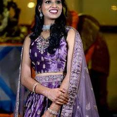 A candid shot of the bride enjoying a moment during her reception. Her smile and the soft lighting showcase the happy atmosphere of the event.