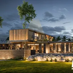The Aravalli farmhouse at dusk, where landscape lighting highlights the minimal architecture and natural materials. The design creates a warm, inviting glow, emphasizing the poetry of open space and the home's connection to its surroundings.