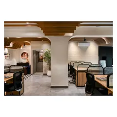 The open-plan workstation area is designed to be bright and comfortable. Arched ceiling fins conceal structural beams and add a sense of warmth and character to the workspace.