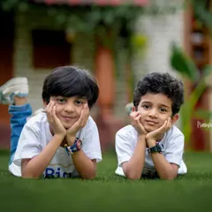 The dynamic duo strikes a pose! We love letting kids be themselves, and these two brothers resting on the grass show their charming personalities.