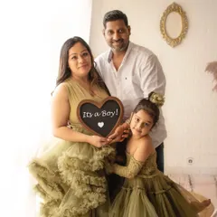 A beautiful family portrait announcing "It's a Boy". The coordinating olive green outfits for mother and daughter are a lovely touch.