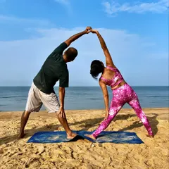 Trikonasana, or Triangle Pose, becomes a beautiful shared stretch in partner yoga. By holding hands, we can deepen the side-body stretch and find more stability in the pose together.