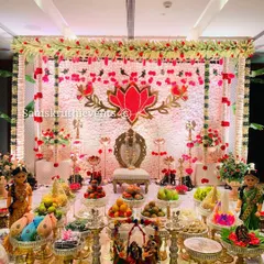 This is a complete view of the half-saree function decor. The grand 21-plate offering is arranged in front of the lotus-themed backdrop, creating a perfect setting for the ceremony.