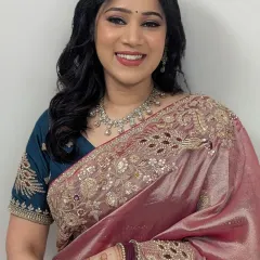 Timeless glam for a member of the bridal party. This look features a soft brown smokey eye, glowing skin, and a beautiful smile, perfect for any wedding event.