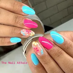 Brighten up your day with this vibrant floral nail art. The combination of turquoise, hot pink, and delicate hand-painted flowers on a sheer base makes for a perfect statement nail.
