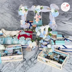 A thoughtful gesture for the groom from the bride's family. This grand display in white and blue features multiple hampers, personalized initial lighting, and a beautiful Ganpati idol for blessings.