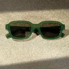 A close-up of the Miniso sunglasses, focusing on the texture and color of the frames under dramatic lighting. This detail shot is great for product pages.