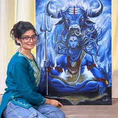 A photo of me with my completed Mahadev canvas painting. It brings me so much joy to create a piece that feels so powerful and to see the vision come to life after many hours of work.