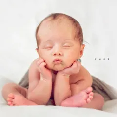 The classic 'froggy' pose is a favorite among parents. It requires patience and careful handling to safely position the baby, highlighting their delicate features and curled-up form against a simple, pure white backdrop.