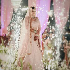 The moment a bride walks in, everything changes. I focus on capturing that grand entrance, complete with dramatic elements like these sparklers, to create a truly unforgettable image of your big day.