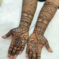 A beautiful and heavy Indian mehndi design perfect for an engagement or the wedding day. The pattern is dense with peacocks and geometric checks, creating a rich and traditional look.