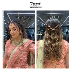 A beautiful braided crown with soft, highlighted curls cascading down. This hairstyle is perfect for an engagement or sangeet, offering a blend of traditional and modern styles.