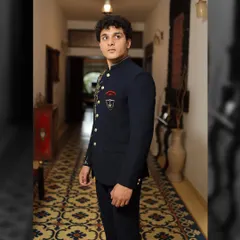 The side profile of this designer Bandhgala highlights the sharp tailoring and the custom crest detail. It’s these small, personal touches that elevate a garment from just clothing to a piece of your story.
