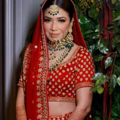 A classic bridal portrait. The bride looks directly at the camera, exuding confidence and happiness on her special day.