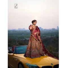 A closer view focusing on the detailed craftsmanship of the lehenga and the model's poised expression against the setting sun.