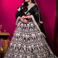 The full view of the black velvet lehenga, showing its grand flare and the beautiful contrast of the silver embroidery.