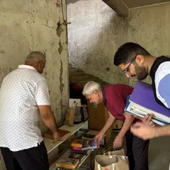 Residents carefully sort through books and other household items during a collection drive. We ensure that usable items like books find new homes or are recycled properly.