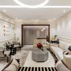 This living room is a study in contrasts, blending bold black and white geometric patterns with soft, neutral fabrics. The result is a sophisticated yet comfortable space, where every piece of furniture and decor makes a statement.