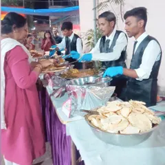 Our staff serving guests at the buffet counter. They wear gloves for hygiene and are trained to be quick and polite.