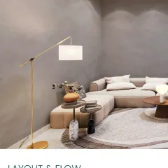 A corner of the Japandi lounge, showing the L-shaped sofa, textured gray walls, and a minimalist floor lamp. The layout and flow are designed for comfort.