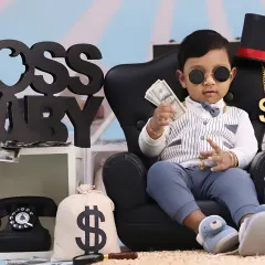 Our popular 'Boss Baby' theme is perfect for showing off your little one's big personality. We style the session with fun props like a tiny CEO chair, play money, and a vintage telephone to create a playful and memorable scene.