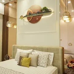It's all in the layers. This bedroom features a stunning 3D wall art piece above the bed, flanked by pendant lights that create a warm, inviting glow. The mix of patterns on the cushions adds personality.