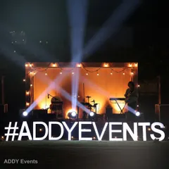 Our services include creating professional stages for entertainment. This setup, complete with a rustic wooden backdrop, string lights, and dramatic spotlights, is perfect for a live band performance at a wedding or corporate event.