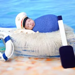 A side view of the little sailor setup, showcasing the details of the boat prop and the peaceful beach backdrop.