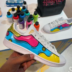 A colorful, pop-art inspired design we painted on a pair of Adidas Stan Smiths during a live event. The bright blue, pink, and yellow create a bold and playful look.