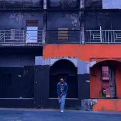 An urban exploration shot against a gritty, colorful backdrop. This is the kind of environment where my streetwear style feels most at home.