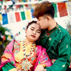 A tender moment captured during a cultural pre-wedding shoot. The groom gently holds the bride, highlighting the beautiful details of her traditional jewelry and attire.