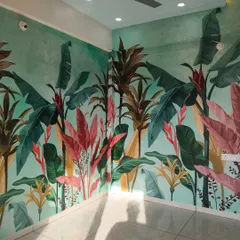 This corner-wrapping mural turns an entire room into a tropical paradise. The continuous design, filled with colorful leaves and plants, creates an immersive experience that is both bold and beautiful.