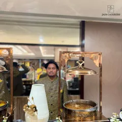 A member of my service team in traditional attire, standing by to assist guests at a beautifully decorated buffet station.