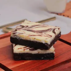 The best of both worlds. Our Cheesecake Brownie features a layer of creamy, tangy cheesecake swirled into our signature dark chocolate brownie base for a truly indulgent experience.