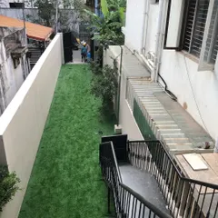 We converted this long, narrow patch of land next to a building into a clean and usable green strip. This is an ideal solution for difficult-to-maintain side yards.