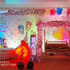This is one of my favorite Dohale Jevan setups. It features a large crescent moon prop, a beautifully decorated swing, and a special Marathi sign saying 'कुणीतरी येणार येणार' to welcome the little one.