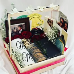 A sweet anniversary gift hamper for a special couple. This pinewood tray includes personalized "Mr" and "Mrs" mugs, a photo frame, cookies, and fresh roses to celebrate their love.