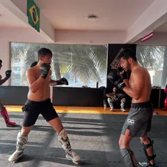 A typical Saturday for our competition team. Two fighters sparring on the mats, working on their MMA game with the Brazilian flag in the background, a nod to the roots of Jiu Jitsu.