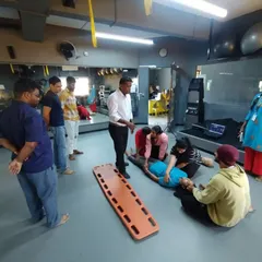 Students learn how to safely move an injured person onto a stretcher. Our first aid training covers various emergency scenarios.