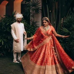 A beautiful portrait of Parth and Dhriti at Rhythm Lonavala. The bride's twirling lehenga adds a sense of movement and joy, while the lush greenery provides a vibrant backdrop.