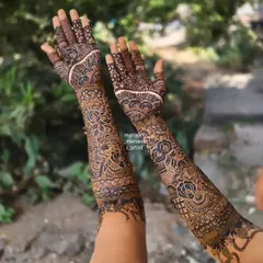 Intricate floral and paisley patterns covering the entire arm for a traditional bridal look.