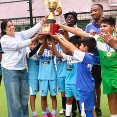 The joy of victory. Our U10 players and coaches lift the championship trophy together after winning the Alpha International Football Academy Tournament.