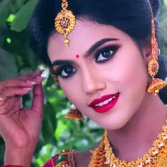 A close-up of a classic South Indian photoshoot look. I focused on creating sharp, defined eyes with a winged liner and a bright red lip, which beautifully complements the traditional gold jewelry.