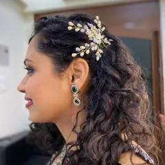 We provided makeup and natural hair styling for this beauty's special event. The delicate hair accessory perfectly complements her defined curls.