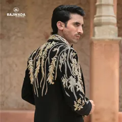 A view of the back of the baroque tuxedo jacket, showing how the lavish embroidery continues around the entire piece for a 360-degree impact.