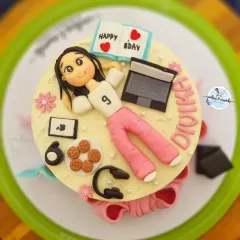 This cake is a perfect match for the birthday girl's hobbies. I created fondant versions of her laptop, headphones, cookies, and even a little book to capture her personality in edible form.